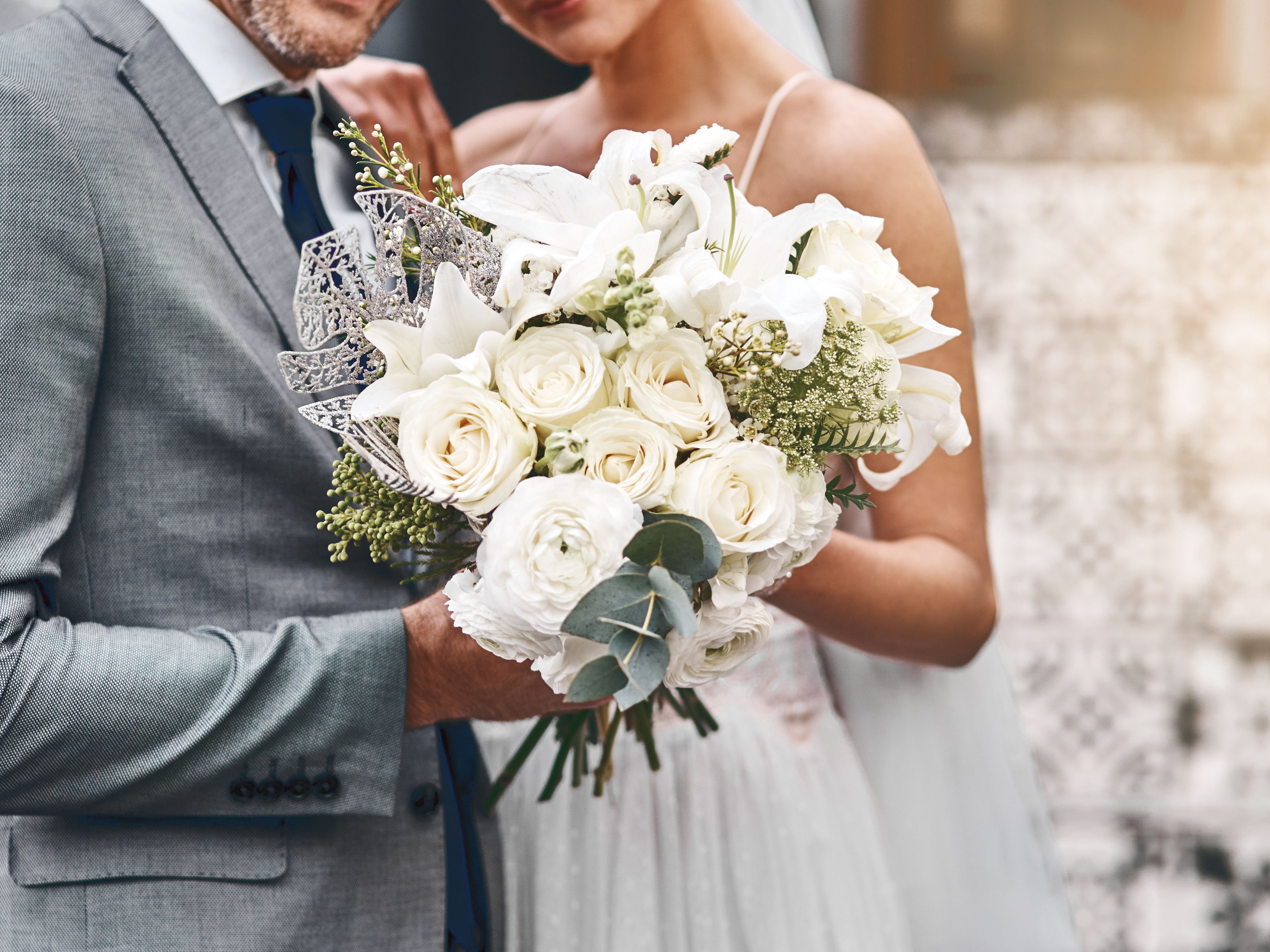 Bride and groom holding wedding bouquet
